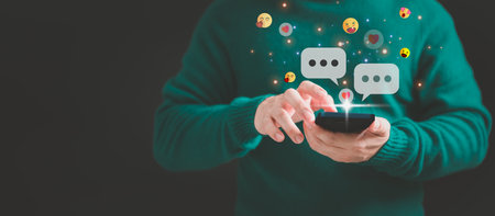 Young man using a smartphone with social media, typing live chat chatting on application communication digital web and social network concept. Social media application chat box.の写真素材