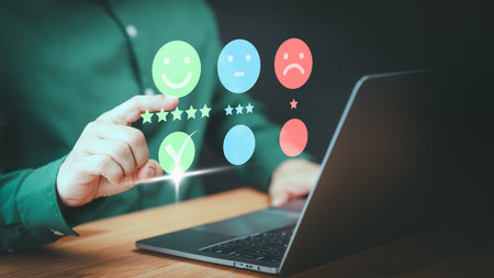 User hand touch virtual screen on smile face icon to give satisfaction in opinion and service. Customer satisfaction survey, service experience rating online application, testimonial feedback review.の写真素材