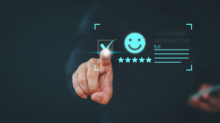 User hand touch virtual screen on smile face icon to give satisfaction in opinion on online application. Customer satisfaction survey, service experience rating, testimonial, feedback and review.の写真素材
