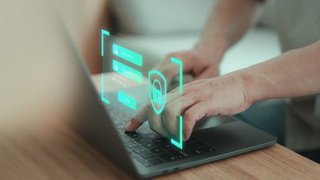 Computer security system. Man typing username and password on a laptop. User authentication system with username and password, information security and encryption, technology secure internet access.の写真素材
