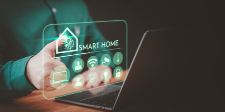 Adult man controlling technology AI smart home devices using a laptop computer with launched application in the bed room. Internet of Things. Iot smart home automation app concept.の写真素材