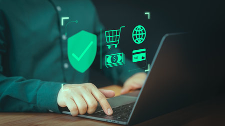 Shopping on online application. Customer use a computer laptop with sign of security protection system on virtual screen. Guarantee, Standard, Certified guarantee approval or secure access internet.の写真素材