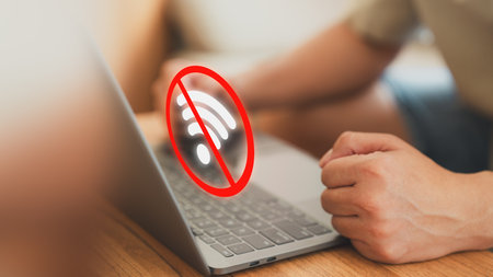 Technology concept of wifi connected but no internet. Man using a laptop computer to connect to wifi but wifi not connected or password is incorrect and waiting to loading digital data form website.の写真素材