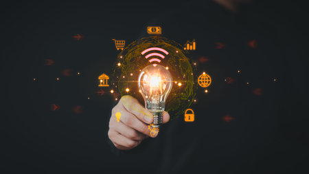 Businessman holding a light bulb with virtual technology global internet connection. Financial and...