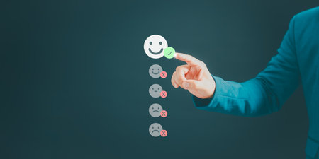 User hand touching the virtual screen on happy smile face icon to give satisfaction in service. Online review concept of opinion rating good, assessment testimonial customer service and feedback.の写真素材
