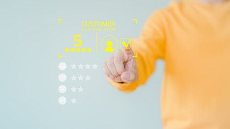 Member hand touch virtual screen on smile face icon to give satisfaction in opinion on online application. Customer satisfaction survey, service experience rating, testimonial, feedback and review.の写真素材