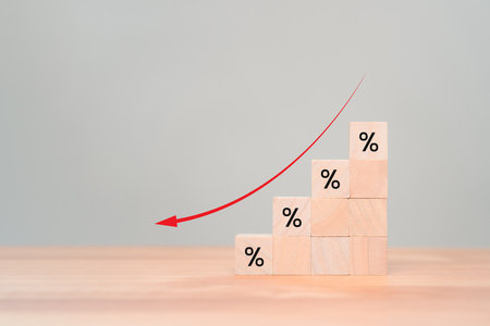 Wooden cube blocks with percentage sign and down arrow icon. Business concept of income decreased, investment reduce,  financial recession crisis, interest rate decline, risk management.の写真素材