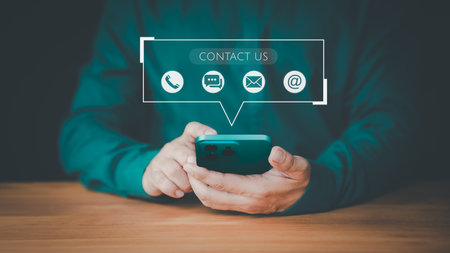 Contact us support hotline, people connect. Man using a smartphone with virtual screen member contact icons ( phone, email, address, live chat). Customer service, helpdesk advice online support.の写真素材