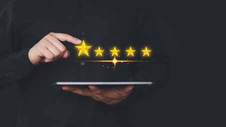 Hand using a tablet give point five stars icon for feedback review satisfaction service opinion and testimonial. Customer service experience assessment and business satisfaction survey.の写真素材