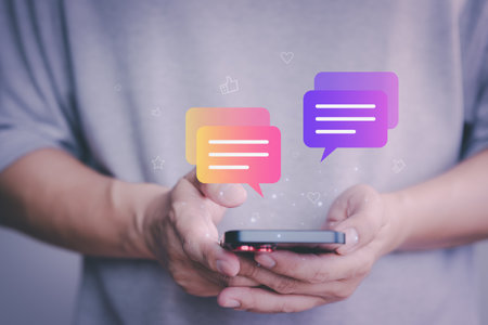 Social media application chat box. Young man using a smartphone with social media, typing live chat chatting on application communication digital website and social network concept.の写真素材