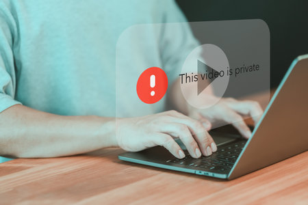 Adult man using a laptop to play social media but this video is blocked or privacy settings have been set. Searching for more internet, and search engine optimization. Subscribing and following.の写真素材