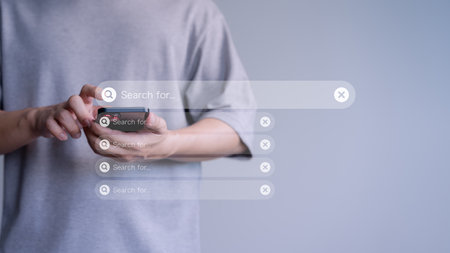 Man using a mobile phone searching browsing internet data information. Search engine optimization the internet with search bar. Best SEO technology networking.の写真素材