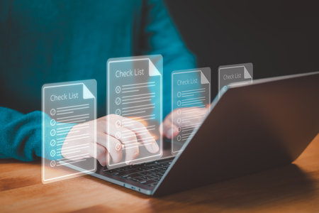 Employee using a computer laptop making online checklist surveyの写真素材