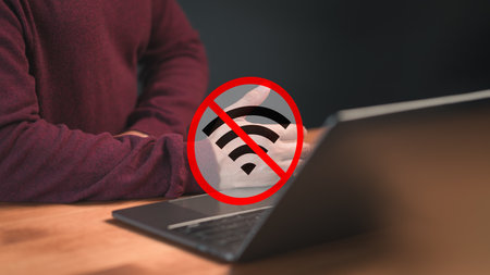 Technology concept of wifi connected but no internet. Man using a laptop computer to connect to wifi but wifi not connected or password is incorrect and waiting to loading digital data form website.の写真素材