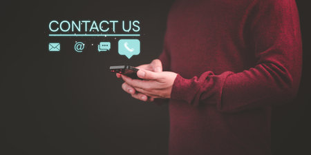 Contact us support hotline, people connect. User man use a smartphone with virtual screen member contact icons ( phone, live chat, email, address ). Customer service, helpdesk advice online support.の写真素材