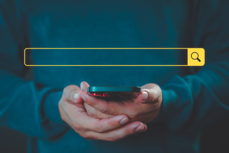 Man using a mobile phone clicking internet search bar. SEO technology networking engine optimization internet with search bar. Searching browsing internet data information concept.の写真素材