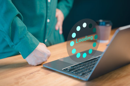 User use a laptop computer to download and update software with waiting to load digital file data...