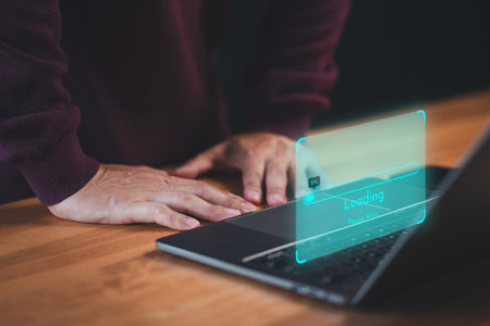 Man use a laptop computer to download and update software with waiting to load digital file data...