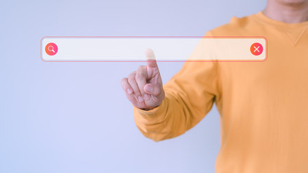 User finger presses the search button on a virtual screen to retrieve data. Concept highlights using a searching console with your website, Search technology involving SEO.の写真素材