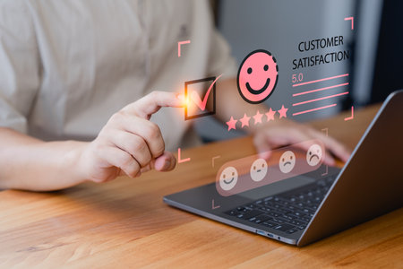 Customer engage in a satisfaction survey, using an online application to rate their service experiences. This evaluation helps determine the quality of service and business reputation rating.の写真素材