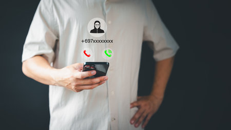 Concept of scam, fraud with a phone from the scammer. Man answering the incoming call. Phone call was from an unknown number. Call center gang or stranger. Hoax person with a fake identity.の写真素材