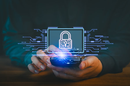Person uses a smartphone displaying a digital padlock icon, symbolizing data security and privacy...