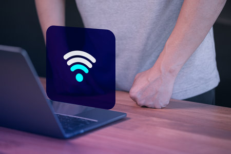 Male user using a laptop computer connect to wi-fi, but wifi signal is very weak, concept technology of waiting for connect to wifi.の写真素材