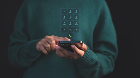 Person dialing on a smartphone with a futuristic virtual keypad interface hovering, symbolizing advanced communication. Concept of digital security and data protection on mobile devices.の写真素材