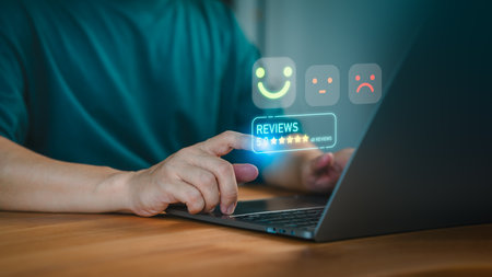 Customer gives a 5 star rating on a digital review system using a laptop. Business service of customer satisfaction, review, positive user experience, decision-making in an online feedback system.の写真素材