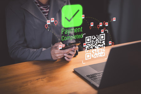 Female client using smartphone to scan QR code to make payment. Customer making payment through mobile phone and scan code for online shopping. Secure online payment, Digital banking.の写真素材