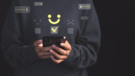 Female customer using a smartphone select a happy face icon on digital feedback. Concept of customer...