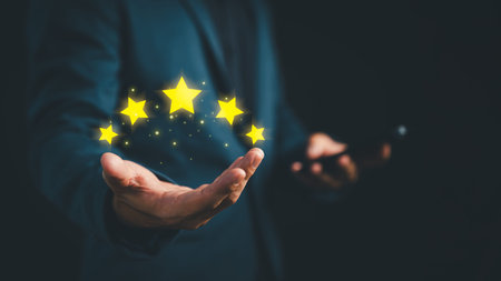 Businessman presenting five glowing stars above his hand, symbolizing top-rated customer service,...