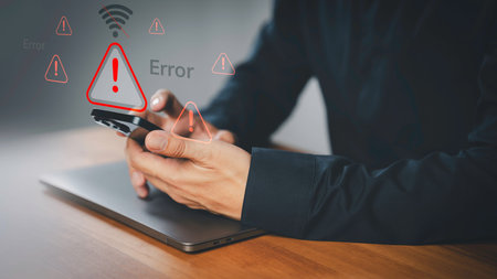 Person holding a smartphone with warning icon and a no Wi-Fi signal symbol. Idea for IT security...