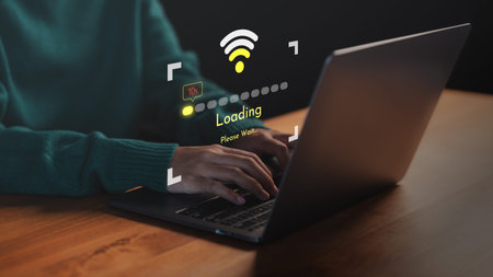 Person using a laptop computer with slow internet connection icon and loading screen interface....