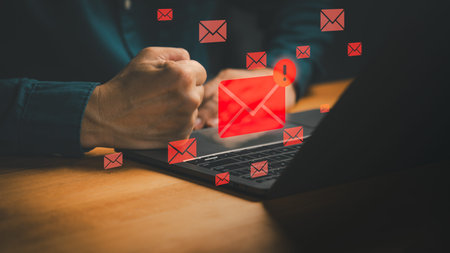 Spam email and phishing attack concept with red warning icon on laptop, symbolizing cybersecurity...