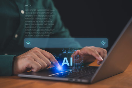 User using laptop computer with AI search bar. Technology concept of artificial intelligence in...