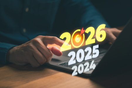 Person selecting the year 2026 on a laptop, symbolizing future planning, business goals, long-term...