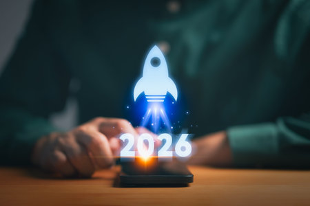 Person using a smartphone with a glowing rocket icon and 2026, symbolizing vision, future target...