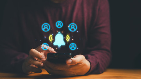 Mobile app notification alert on smartphone. Social media community network, digital communication, and connection concept with glowing bell and user icons.