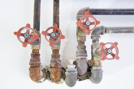 Old Heating Cooling Water Plumbing Pipes with Valves Macro Closeup Frontの写真素材