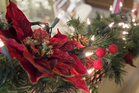 Christmas Decoration Garland with Poinsettia Pine Cones and Lights on Staircaseの写真素材