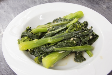 Steamed Chinese Kai Lan Green Vegetables with Garlic and Oilの写真素材
