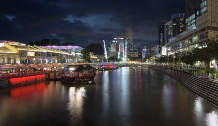 SINGAPORE, SINGAPORE - MARCH 13, 2013 : Nightlife at Clarke Quay Along Singapore River Panorama at Blue Hour. A popular tourist attraction in Singapore with boat rides restaurants night clubs historic houses and shopping mall.のeditorial素材