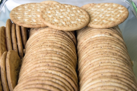 Round Whole Wheat Crackers Stacked in Glass Containerの写真素材