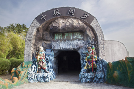 SINGAPORE - FEBRUARY 1, 2014  Entrance to the Ten Courts of Hell with Ox-Head and Horse-Face Guradians at Haw Par Villa Theme Parkのeditorial素材