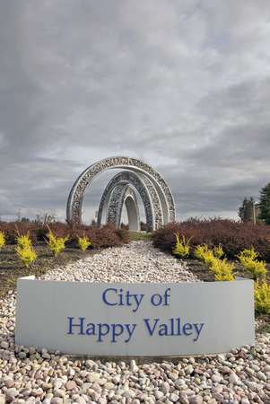 HAPPY VALLEY, OREGON - MARCH 30, 2014: City of Happy Valley Sign with Outdoor Steel and Stone Art Sculpture at Entrance to th city. Happy Valley is in Clackamas County  Oregon and Incorporated in 1965.のeditorial素材