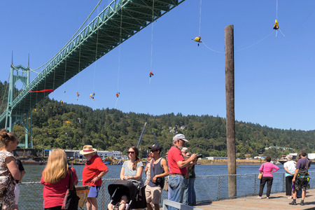 PORTLAND, OREGON - JULY 29, 2015: Greenpeace USA activists rappelled off St Johns Bridgein Portland Oregon in protest blocking the Shell Oil Icebreaker Vessel leaving for oil drilling in the Arctic with spectators and supporters on pierのeditorial素材