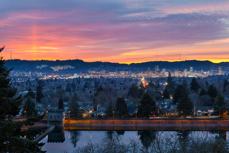 Colorful sunset over Mt Tabor City Park Reservior and the skyline of Portland Oregon downtownの写真素材