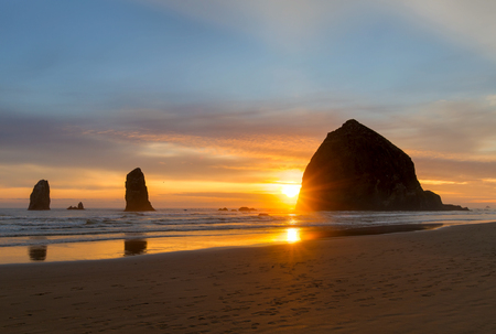 Haystack Rock and the Needles at Cannon Beach on the Oregon Coast during Sunsetの写真素材