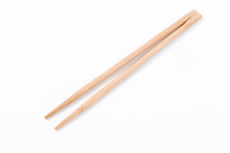 Top view of a pair of chopsticks made of wood insulated on a white background.の写真素材